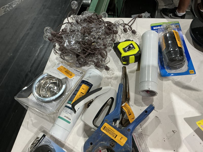 Condition photo showing As Is for assorted home improvement lot (small tools, screw, home accessories, etc.)