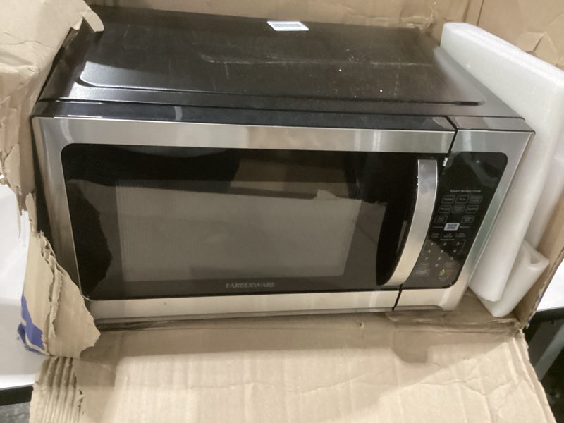 Condition photo showing Good Condition for Farberware 1.2 Cu. Ft. Countertop Microwave Oven – 1000 Watts Power, Smart Sensor Auto Cook Settings, Defrost, Easy Clean and Child Safety Lock - Stainless 1.2 Cu.Ft Stainless Steel, NOT TESTED, AS IS