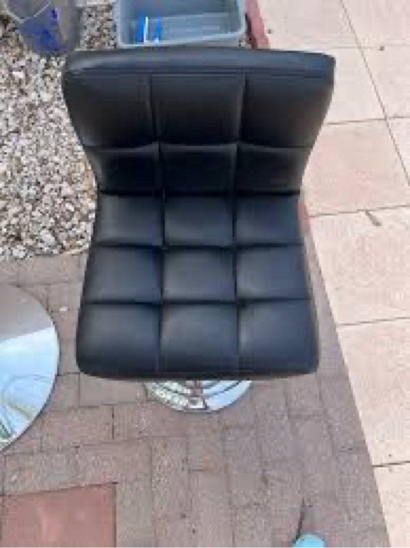 Porthos Home bar stool with a black faux leather upholstered seat