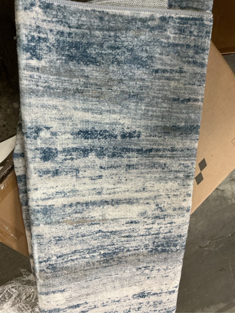 Condition photo showing As Is for sunset over sea blue/gold washable modern abstract area rug