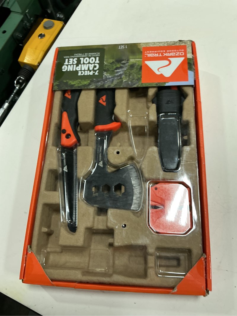 Condition photo showing As Is for ozark trail 7-piece camping multitool set with hammer, axe, flashlight, and knives