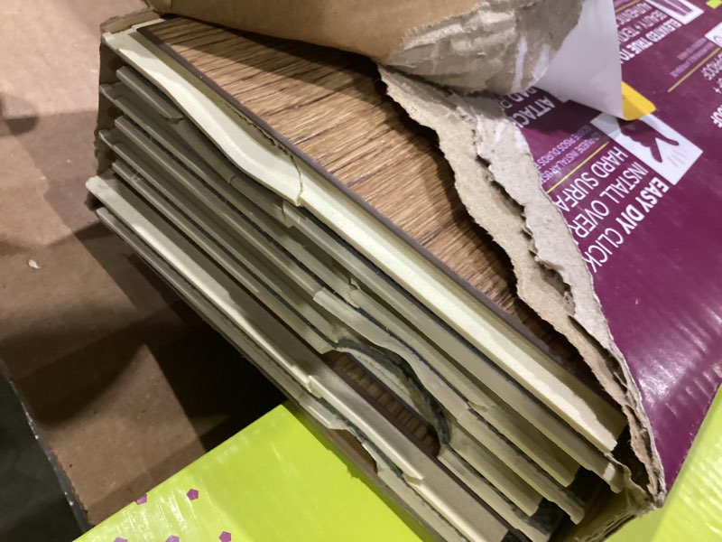 Condition photo showing As Is for smartcore by coretec floors lexington oak brown wood look 12-mil x 6-in w x 48-in l waterproof and water resistant interlocking luxury vinyl plank flooring ( 15.76-sq ft carton )
