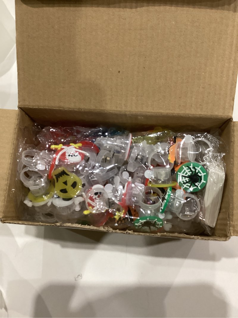 Condition photo showing As Is for 100 PCS Halloween Party Favors for Kids, Halloween Glow in The Dark Toys Bulk Party Supplies Light Up Rotating Necklace LED Ring Halloween Goodie Bag Fillers Treats for Classroom Prizes Trick or Treat Style 1