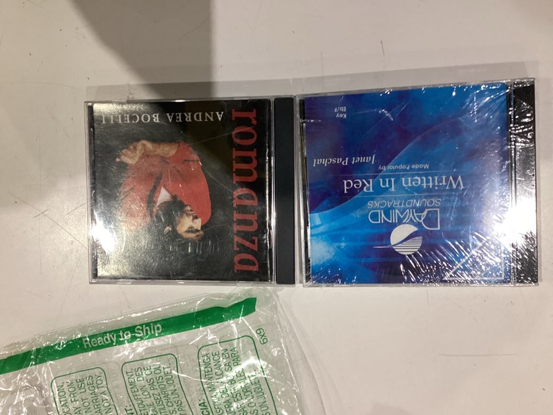 Condition photo showing Good Condition for written in red accompaniment/performance track and andrea bocelli cd romanza