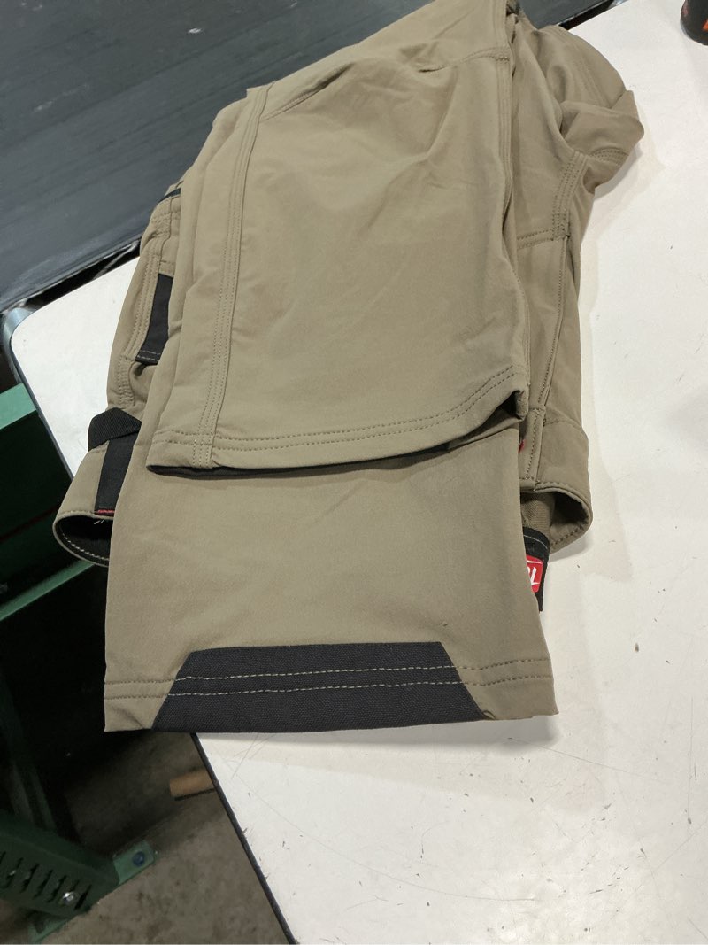 Condition photo showing As Is for men's 34 in. x 32 in. brown freeflex tech work pants with 7 pockets