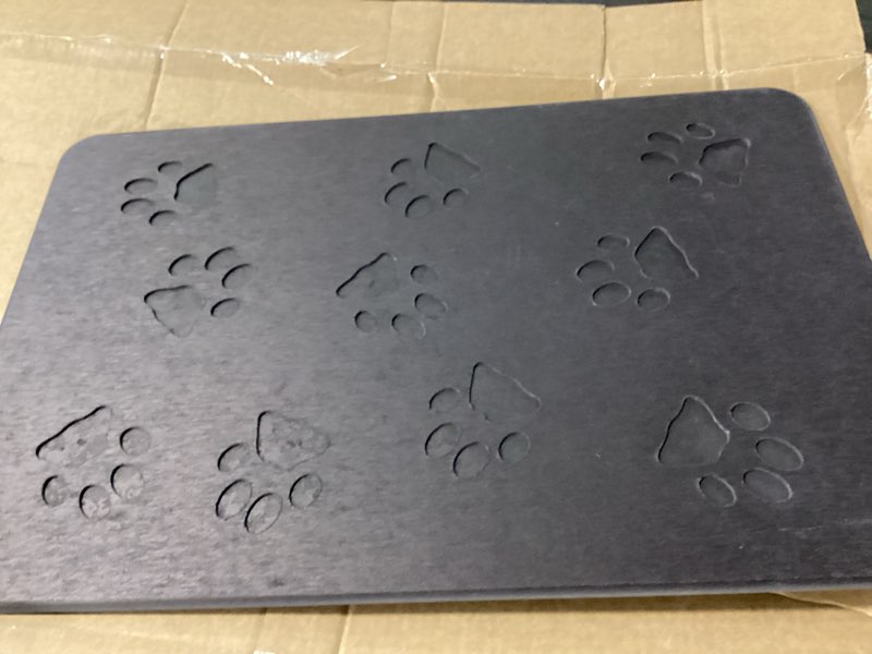 Condition photo showing Good Condition for gray, non-slip pet feeding mat featuring embossed cut-out paw prints 