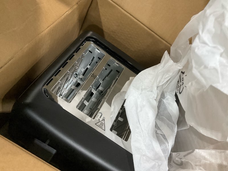 Condition photo showing As Is for Amazon Basics 4 Slice Toaster, With 7 Browning Settings, Extra Wide Slots For Bagels and Special Breads, Removable Easy-to-Clean Crumb Trays, Cancel/Defrost/Bagel Buttons, 1500W, Black & Silver 4 Slice Matte Black Front