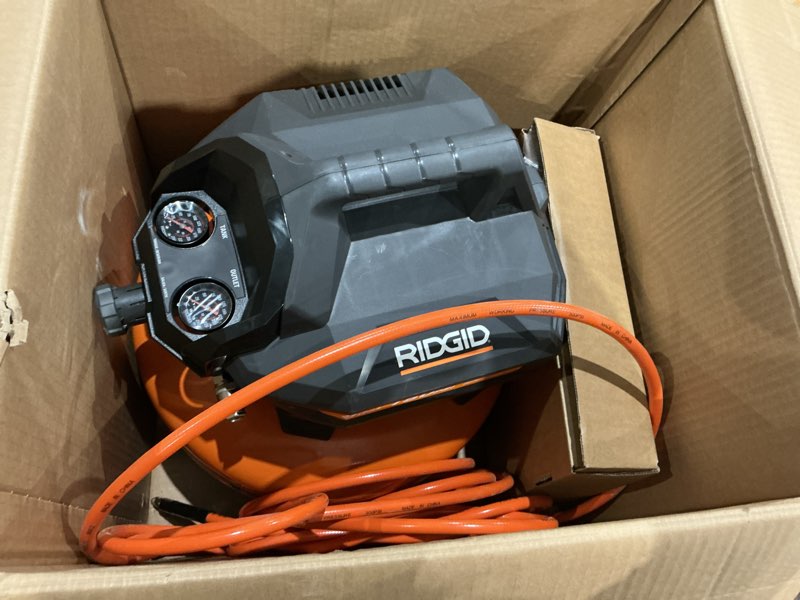 Condition photo showing As Is for 6 gal. 150 psi portable electric oil-free jobsite pancake air compressor with 25 ft. air hose and 18ga brad nailer
