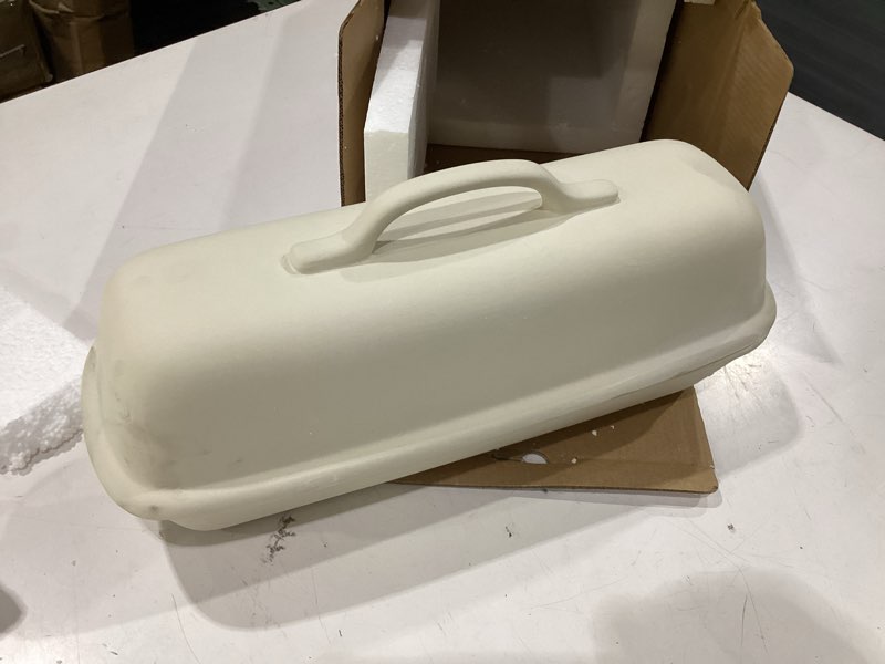 Condition photo showing New/Like New for sassafras superstone® covered bread baker with lid - bisque glazed exterior and unglazed interior stoneware bakeware - bakes an artisan italian bread with crusty crust and a light crumb