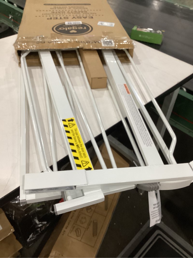 Condition photo showing New/Like New for regalo safety 38" baby gate for doorways & bottom of stairs, pressure mount design for babies, toddlers & pets, tested & safe for 30 years, american designed, american owned, white white 29-38.5"w x 30"h