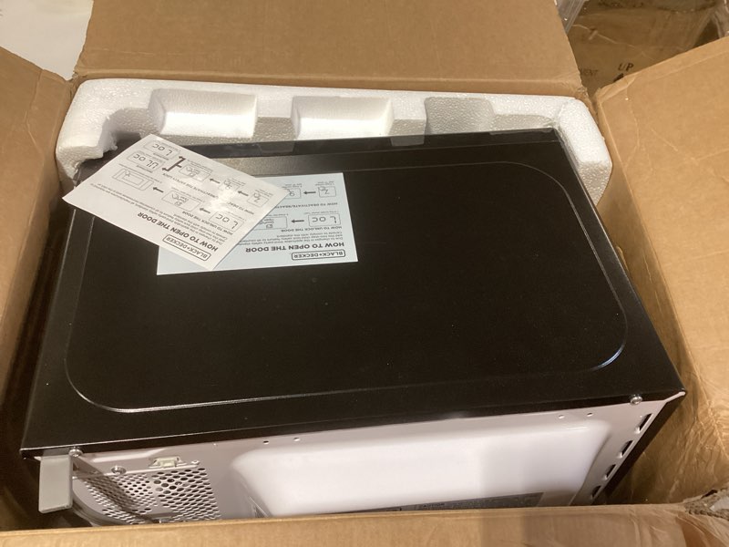 Condition photo showing As Is for black+decker em720cb7 digital microwave oven with turntable push-button door, child safety lock, 700w, stainless steel, 0.7 cu.ft 0.7 cu. ft.