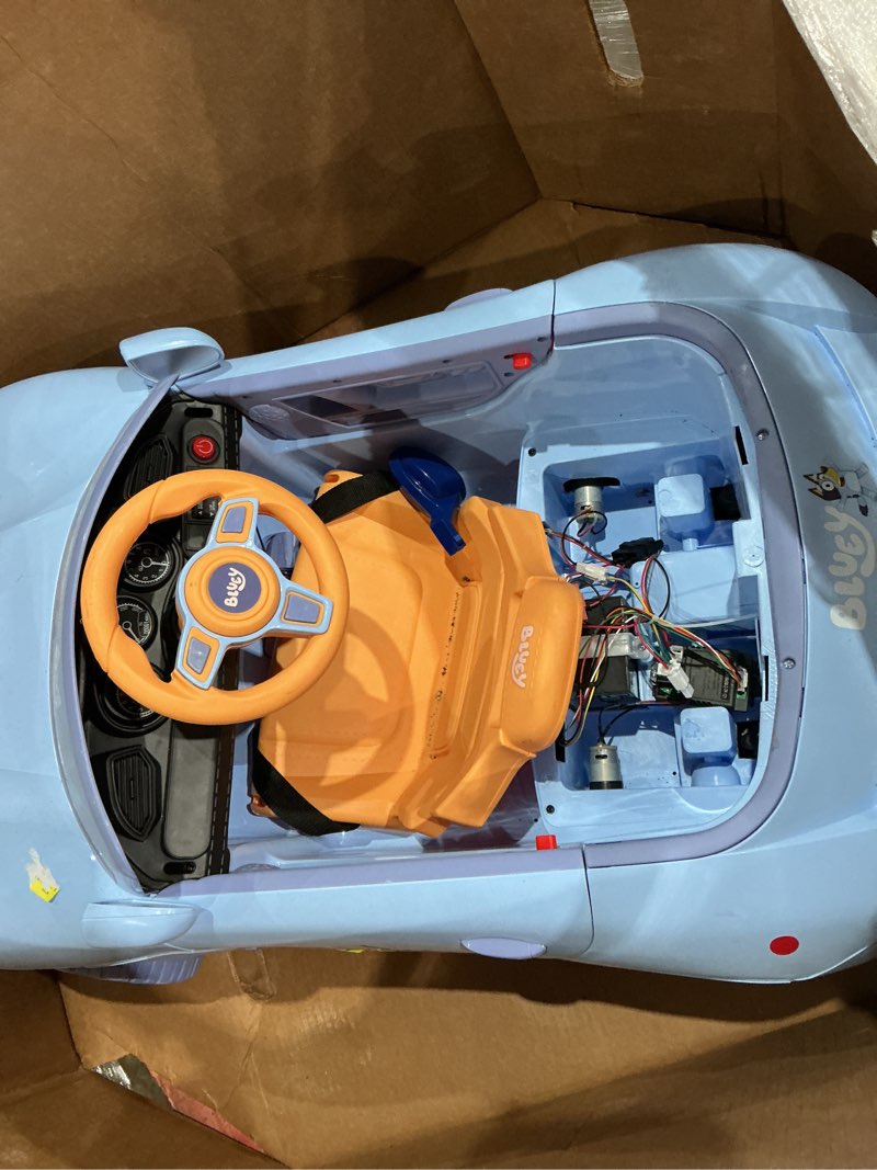 Condition photo showing As Is for licensed kids 12-volt battery powered convertible ride-on - bluey