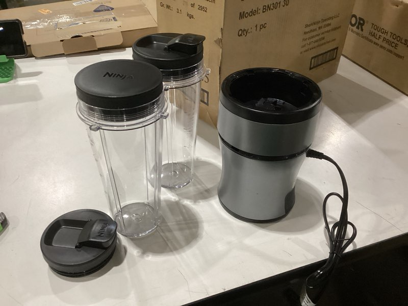 Condition photo showing As Is for incomplete no blades ninja bn301 nutri-blender plus compact personal blender, 900-peak-watt motor, frozen drinks, smoothies, sauces & more, (3) 20 oz. to-go cups, (2) spout-lids (1) storage-lid, dishwasher safe, silver push to blend + 3 cups