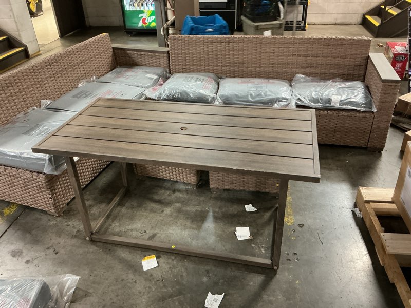 Condition photo showing As Is for outdoor patio sectional with ottoman and table