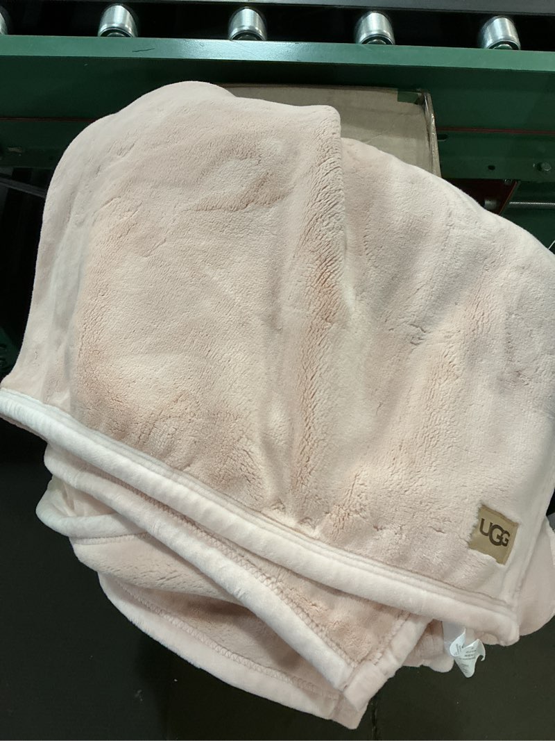 Condition photo showing As Is for ugg coco plush fleece throw blanket – soft & cozy blanket for couch, bed & sofa, perfect for home decor, house warming gifts or luxurious birthday gifts for women, 50" x 70", pink himalayan salt light pink throw