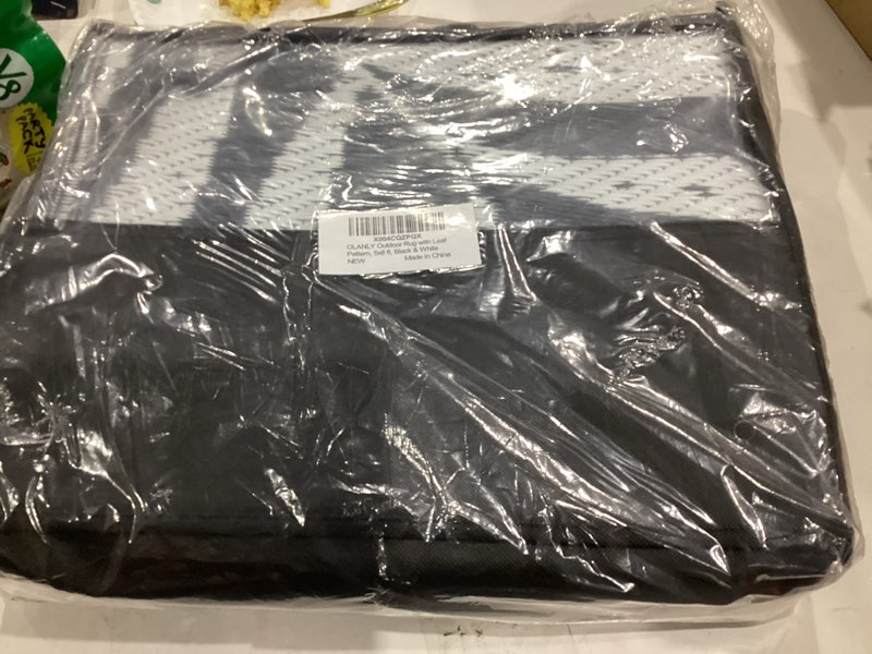 Condition photo showing New/Like New for OLANLY Waterproof Outdoor Rug 5x8 ft, Reversible Outdoor Plastic Straw Rug with Leaf Pattern, RV Mat, Indoor Outdoor Carpet for Patio, Camping, Balcony, Deck, Backyard, Black & White Black & White 5' x 8' (Rectangular)