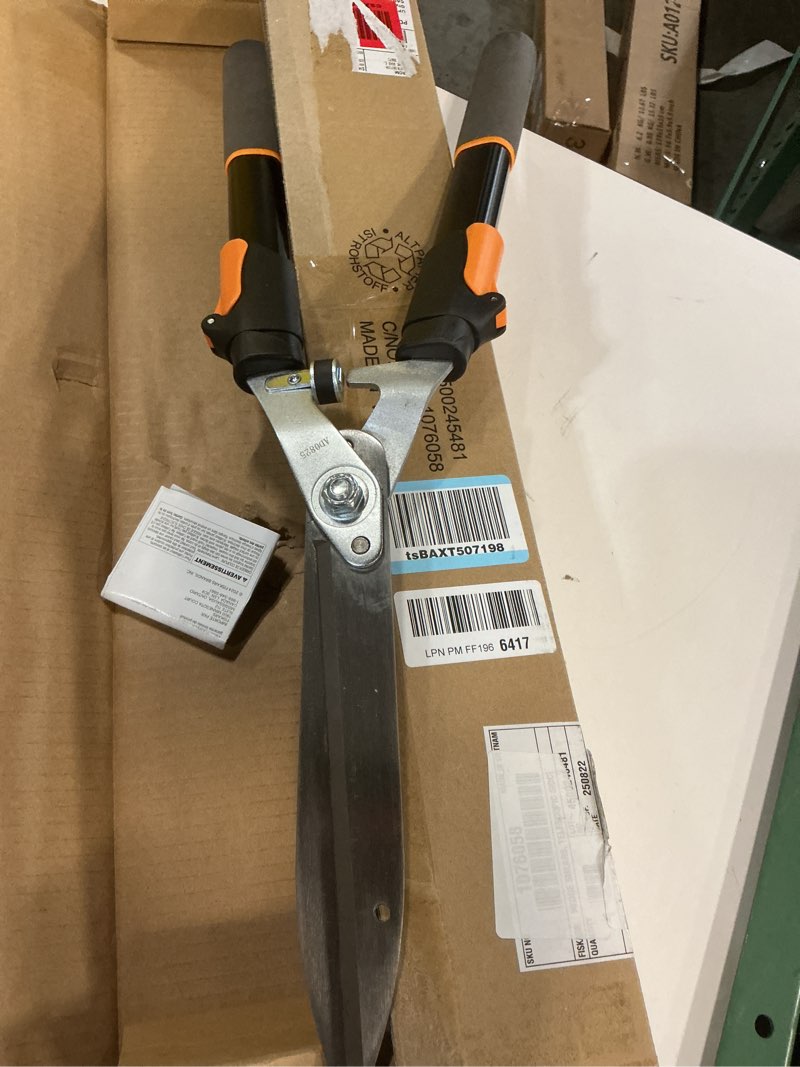 Condition photo showing Good Condition for fiskars power-lever extendable hedge shears, self-sharpening serrated steel blades for clean cuts, handles adjust 25"-33" for high reach, multiplies leverage for 2x power, 10" blades, orange/black