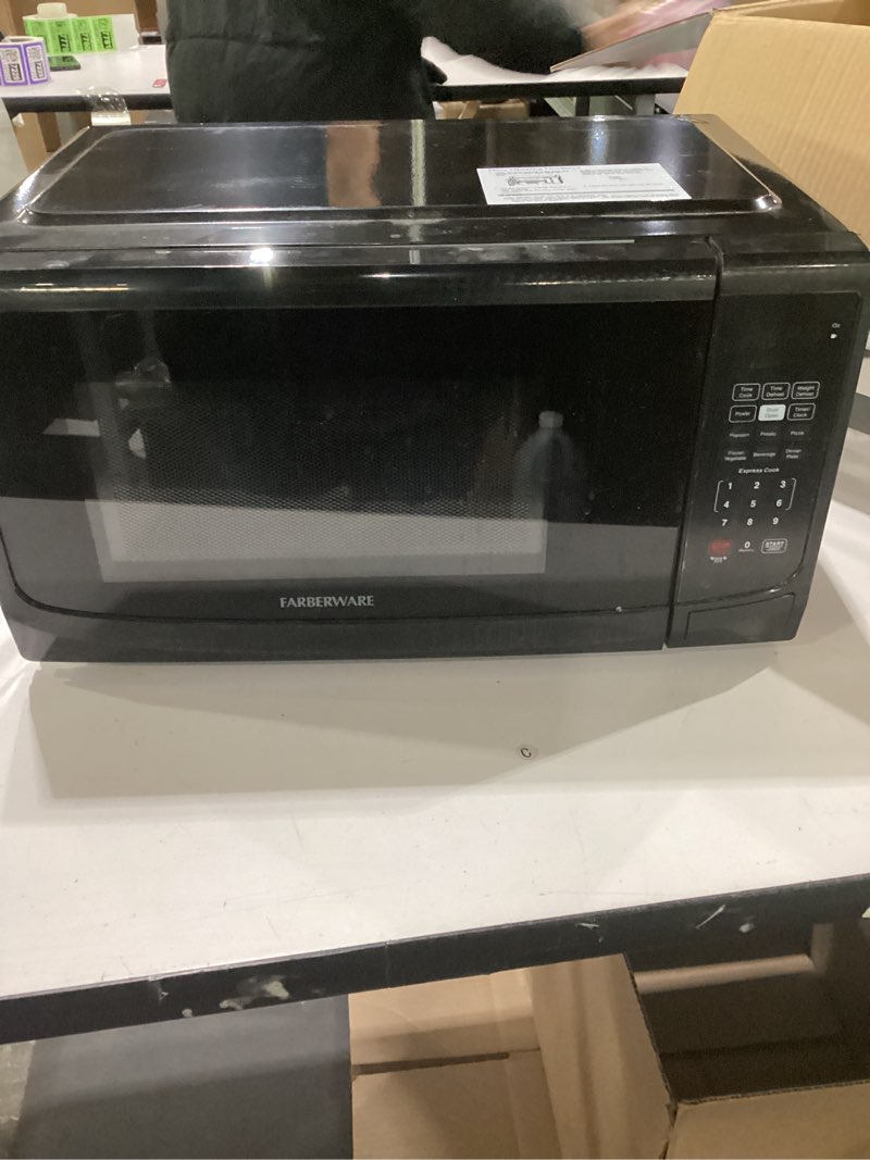 Condition photo showing As Is for NOT TESTED Farberware 0.7 Cu. Ft. Countertop Microwave Oven – 700 Watts Power, Auto Cook Settings, Defrost, Easy Clean and Child Safety Lock - Black 0.7 Cu. Ft Black MISSING TRAY