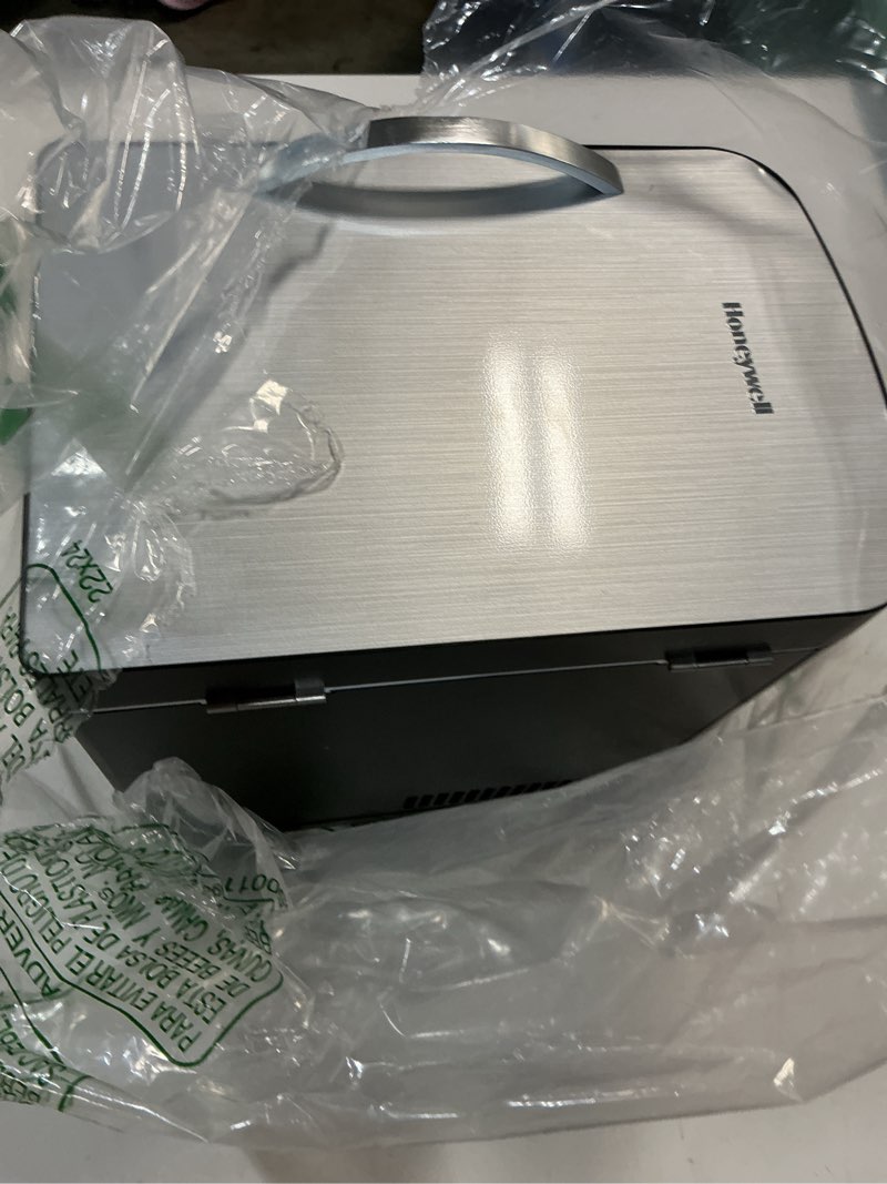 Condition photo showing As Is for honeywell 4 liter personal fridge cools or heats & provides compact storage for skincare, snacks, or 6 12oz cans
