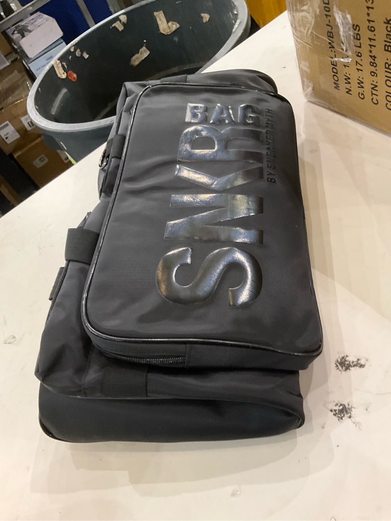 black duffel-style sneaker bag by the brand Sneaker Myth