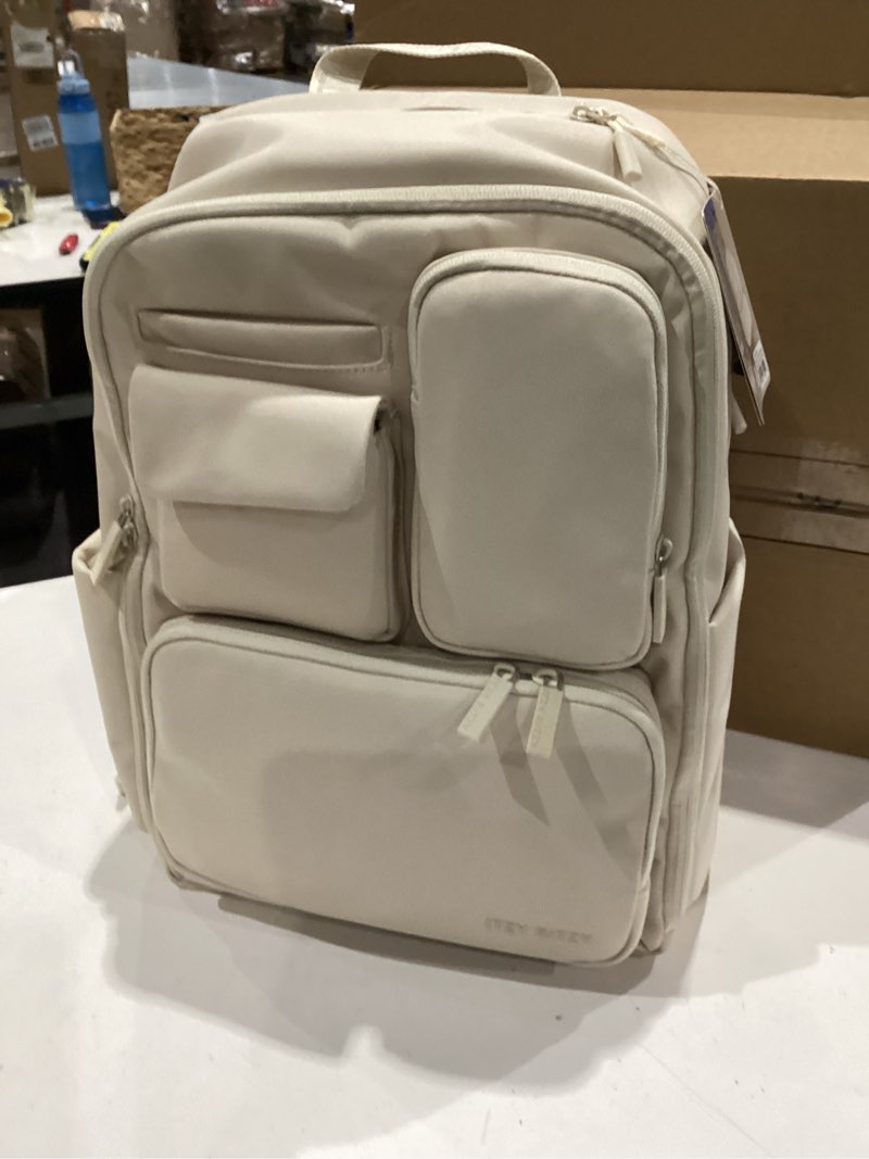 Condition photo showing Good Condition for itzy ritzy utility diaper bag backpack – features 17 pockets (including 2 insulated bottle holders) & trolley sleeve and includes stroller straps & changing pad – part of the belong collection (cream)