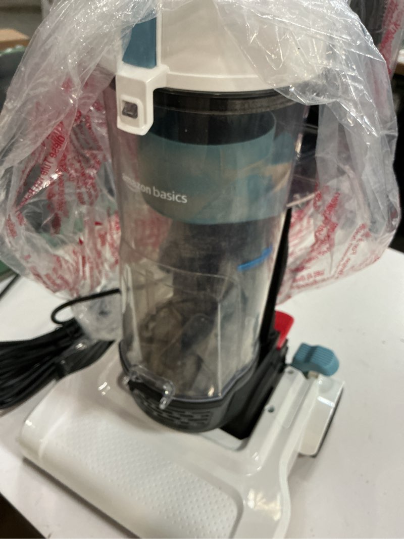 Condition photo showing As Is for Amazon Basics Upright Bagless Vacuum Cleaner for Carpet and Hard Floors, With Crevice and Upholstery Tools, Detachable Handle, Lightweight (8.4 lbs), 1.7L Dust Cup, 720W, 25ft Cord, Black/White