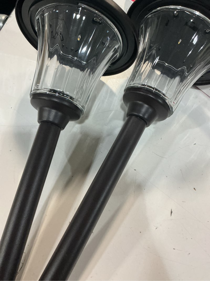 Condition photo showing As Is for 5-lumen solar black melville pathway lights
