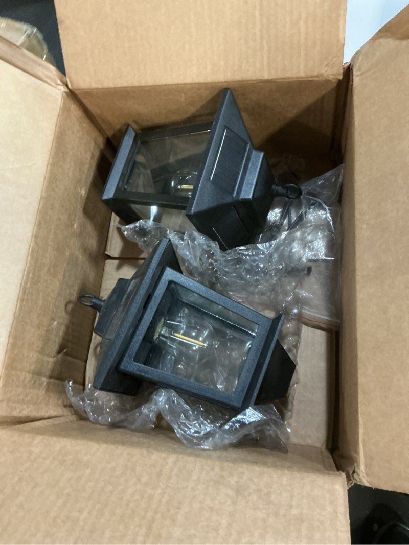 Condition photo showing As Is for pasamic 2 pack solar wall lanterns with replaceable bulb,outdoor hanging lights with 4 solar panels,dusk to dawn led outdoor wall sconce, anti-rust waterproof lanterns with hooks,3000k warm white 2 pack black