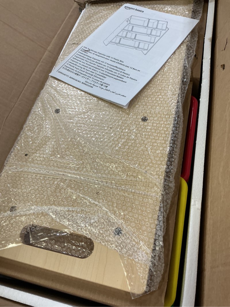 Condition photo showing Good Condition for Amazon Basics Kids Toy Storage Organizer With 12 Plastic Bins, Natural Wood With Bright Bins, 10.9" D x 33.6" W x 31.1" H Natural Wood With Bright Bins 10.9 Inch D X 33.6 Inch W X 31.1 Inch H