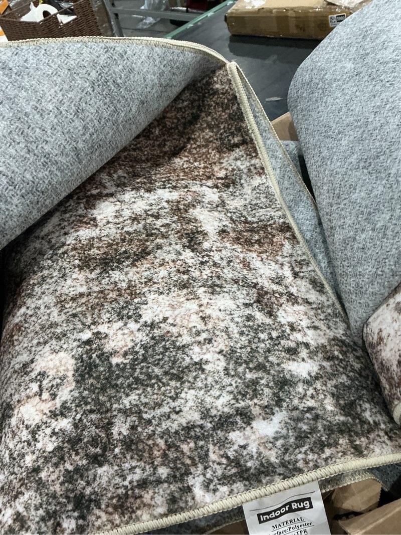 Condition photo showing As Is for ripped large indoor area rug