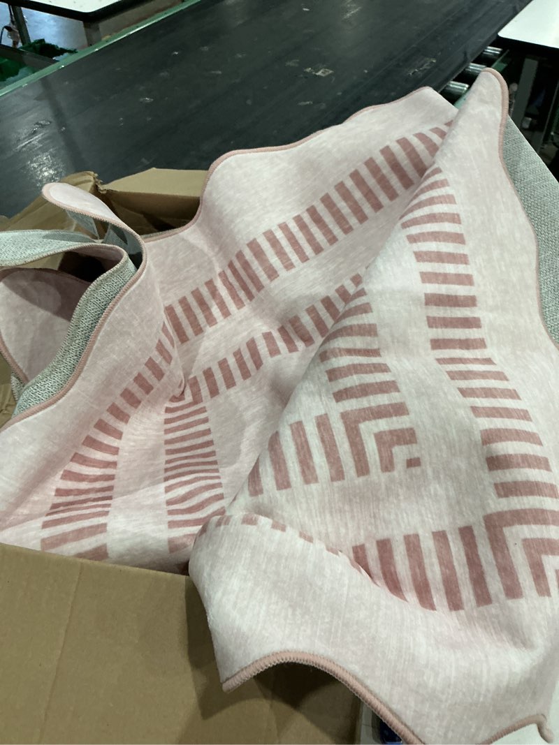 Condition photo showing Good Condition for unknown brand and size. scalloped pink geometric area rug.