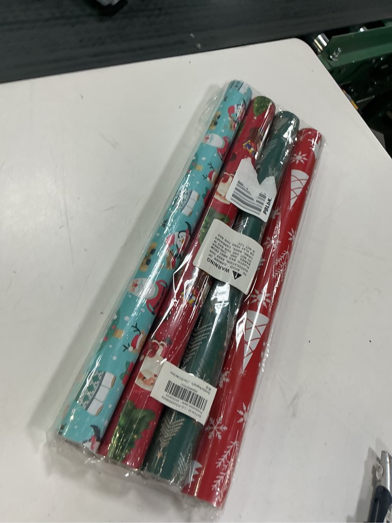 Condition photo showing Good Condition for Christmas Wrapping Paper (4 Rolls, 93 sq. ft. ttl): Funny Snowmen, Snowflakes, Reindeer, Bear, Christmas Trees and Santa Claus with Gifts Design for Holiday Gift Wrap- 17 Inches x 16.5 Feet Per Roll