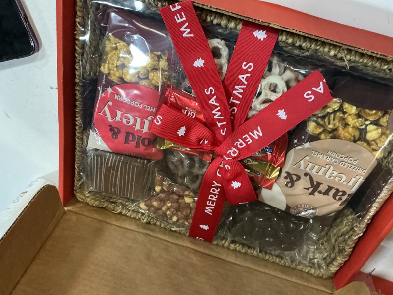 Condition photo showing New/Like New for a gift inside merry christmas chocolate caramel and crunch grand gift basket ( bb 09/25/2026)
