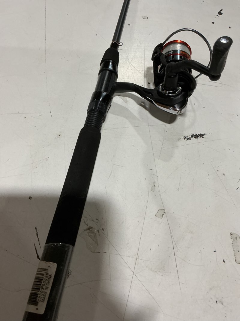 Condition photo showing Good Condition for ozark trail grit stick spinning fishing rod and reel combo, 6-foot 6-inch 2-piece medium action rod, size 3000 reel, left & right hand retrieve, black with orange