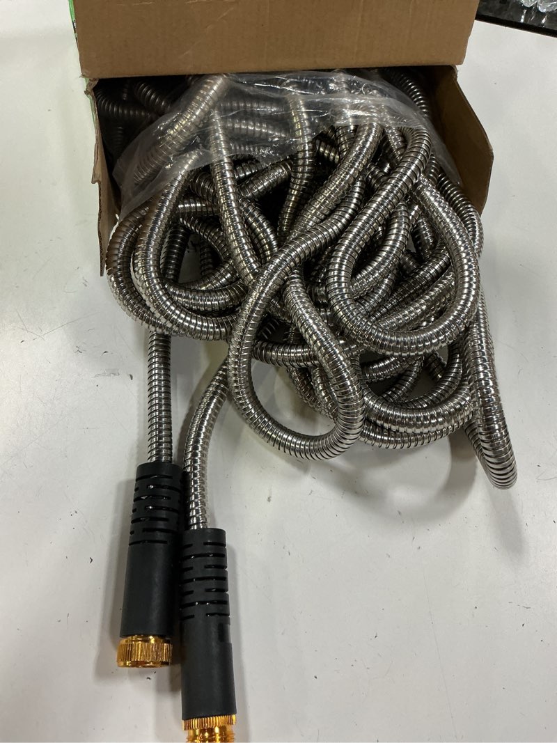 Condition photo showing As Is for garden hose 50ft, heavy duty stainless steel water hose with 10 functional nozzles, no kink, lightweight and flexible, easy to use and store, strong and sturdy, suitable for yard and lawn