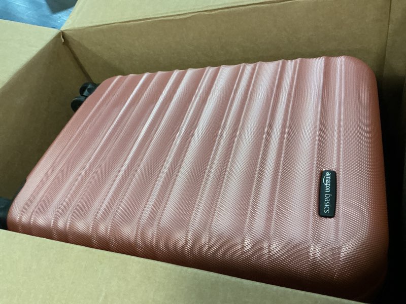 Condition photo showing As Is for amazon basics 21" hardside carry-on luggage, hardshell suitcase with wheels, expandable for up to 25% more space, with scratch-resistant surface, four multi-directional wheels, rose gold rose gold carry-on