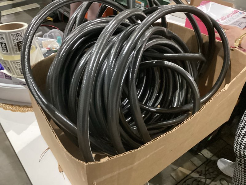 Condition photo showing As Is for long black waterhose size unknown