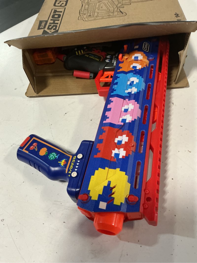 Condition photo showing As Is for xshot skins pro series 1 pac-man long shot blaster by zuru with 40 darts, air pocket technology darts and dart storage, outdoor toy, teens and adults