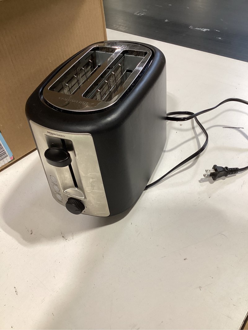 Condition photo showing Good Condition for amazon basics 2 slice toaster, extra wide slots for bagels, 6 browning settings, removable crumb tray, defrost/cancel/bagel buttons, cord wrap, 900w, black & silver 2 slice silver front