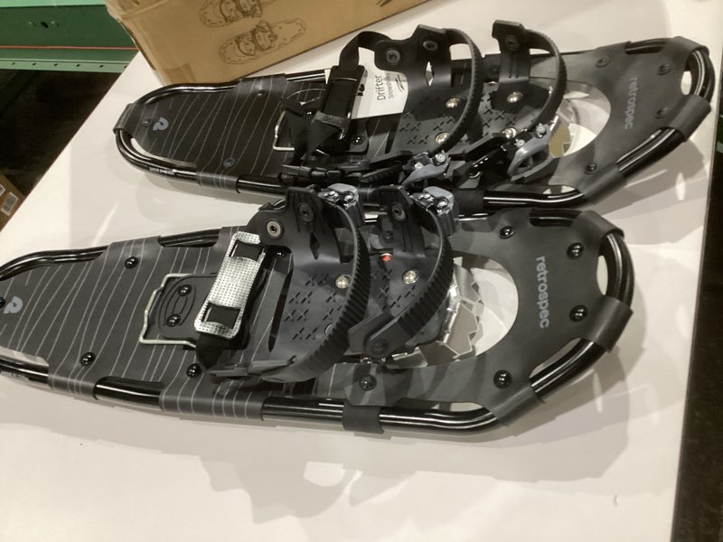Condition photo showing New/Like New for Retrospec Drifter Snowshoes for Women & Men - Lightweight Aluminum Frame Snow Shoes with Double Ratchet Binding System, Heel Lifts & Carry Bag for All Terrain Hiking & Winter Sports Black Ice 25" Snowshoes