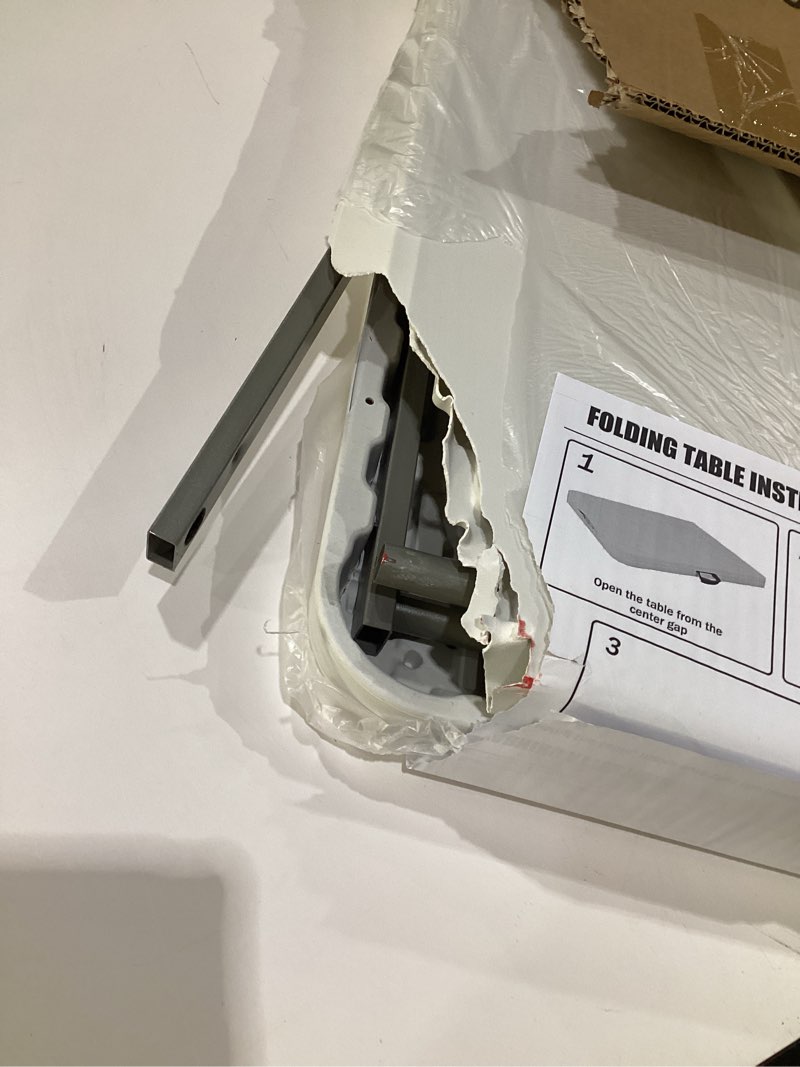 Condition photo showing As Is for (TABLE IS DAMAGED) Folding Table 5 FT Camping Table Portable Heavy Duty Plastic Rectangular Outdoor Dining Table Steel Legs Fold-in-Half with Carrying Handle for Indoor,Picnic,Party,Wedding,Events(White) 5 FT White 1