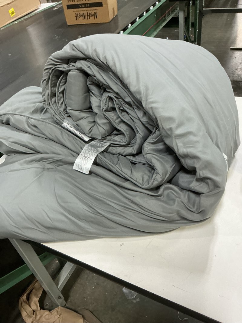 Condition photo showing As Is for amazon basics soft, lightweight king size comforter set, all-season down-alternative 3-piece bedding set, pinch pleat design with piped edges, dark grey dark grey king