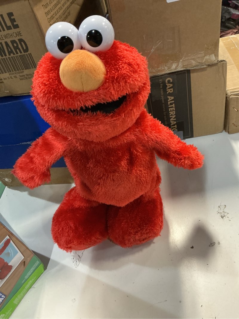 Condition photo showing Good Condition for sesame street hokey pokey elmo 14” interactive plush toy, sings, dances & plays music, bilingual stuffed animal for pretend play, soft & huggable, ages 18 months and up by just play