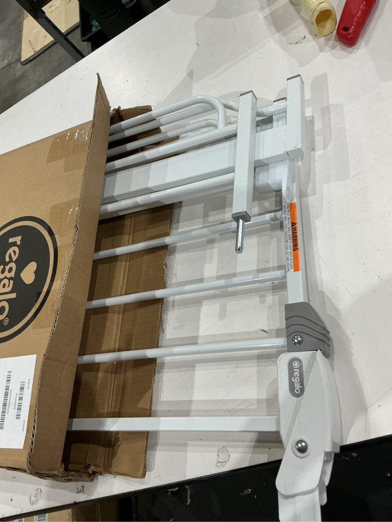 Condition photo showing As Is for regalo safety 29-38.5" baby gate for doorways & bottom of stairs, pressure mounted baby gate with door for babies, toddlers & pets, tested & safe for 30 years, american designed, american owned, white white 29-38.5"w x 30"h