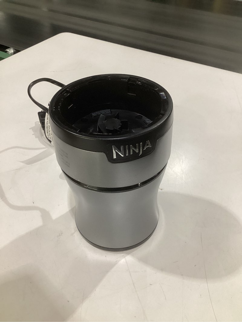 Condition photo showing As Is for (parts, just the base)ninja bn301 nutri-blender plus compact personal blender, 900-peak-watt motor, frozen drinks, smoothies, sauces & more, (3) 20 oz. to-go cups, (2) spout-lids (1) storage-lid, dishwasher safe, silver push to blend + 3 cups