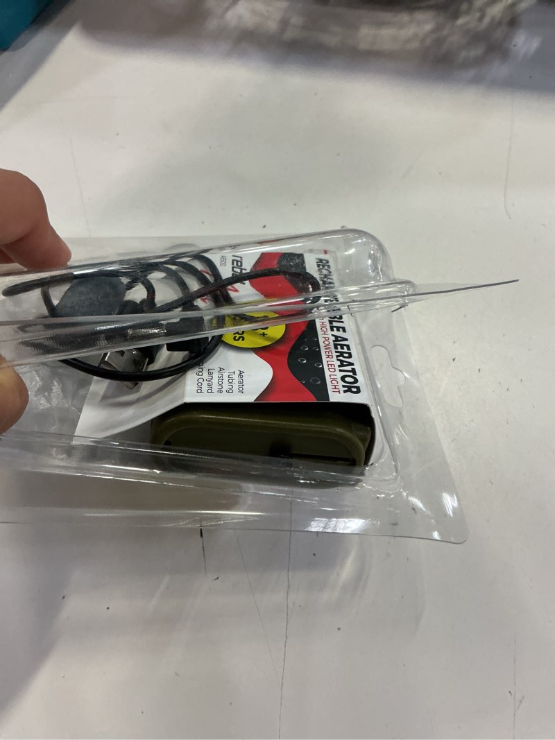 Condition photo showing As Is for rebelfin pocket sized rechargeable 18 hour army green foam bucket aerator with powerful led light to aerate up to 6 gallons of freshwater minnows.