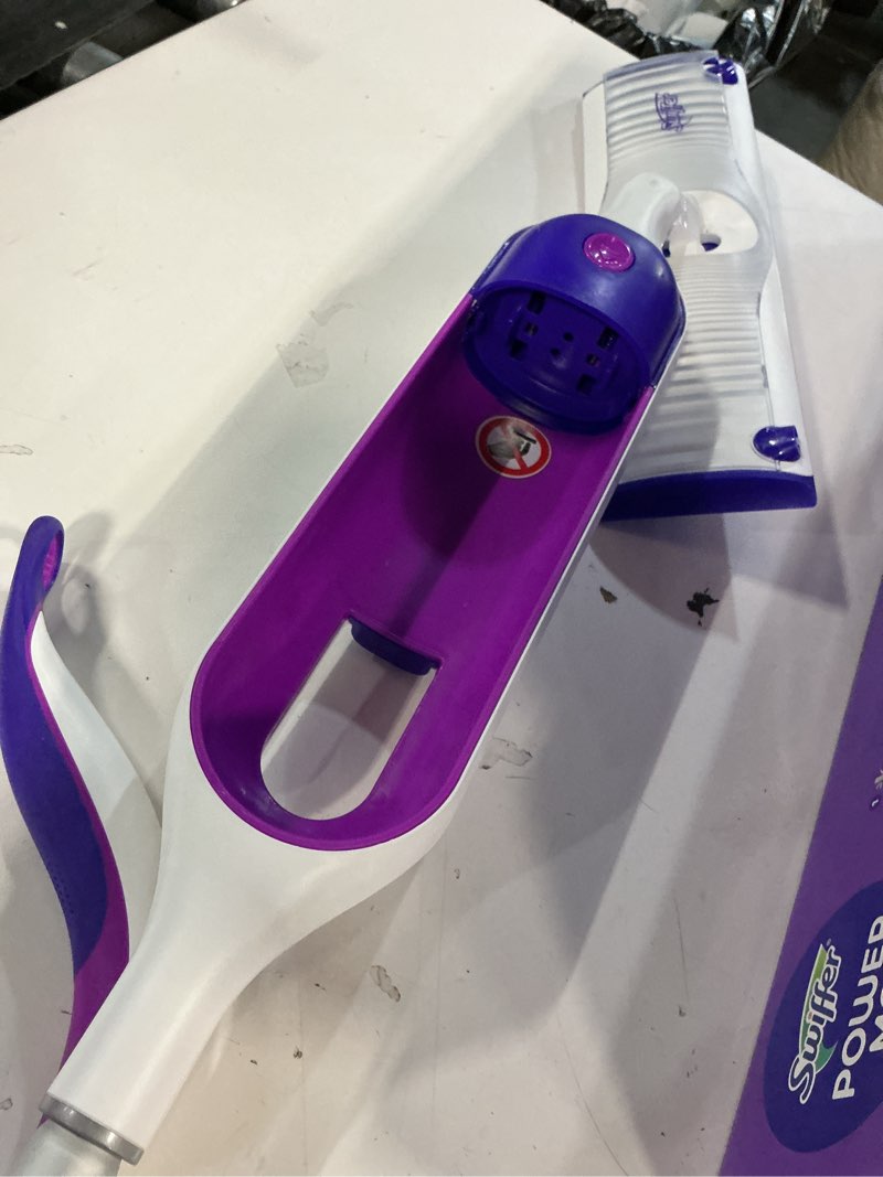 Condition photo showing As Is for swiffer powermop multi-surface mop kit for floor cleaning, includes powermop, 2 mopping pad refills, 1 cleaning solution with fresh scent and 2 batteries purple and white