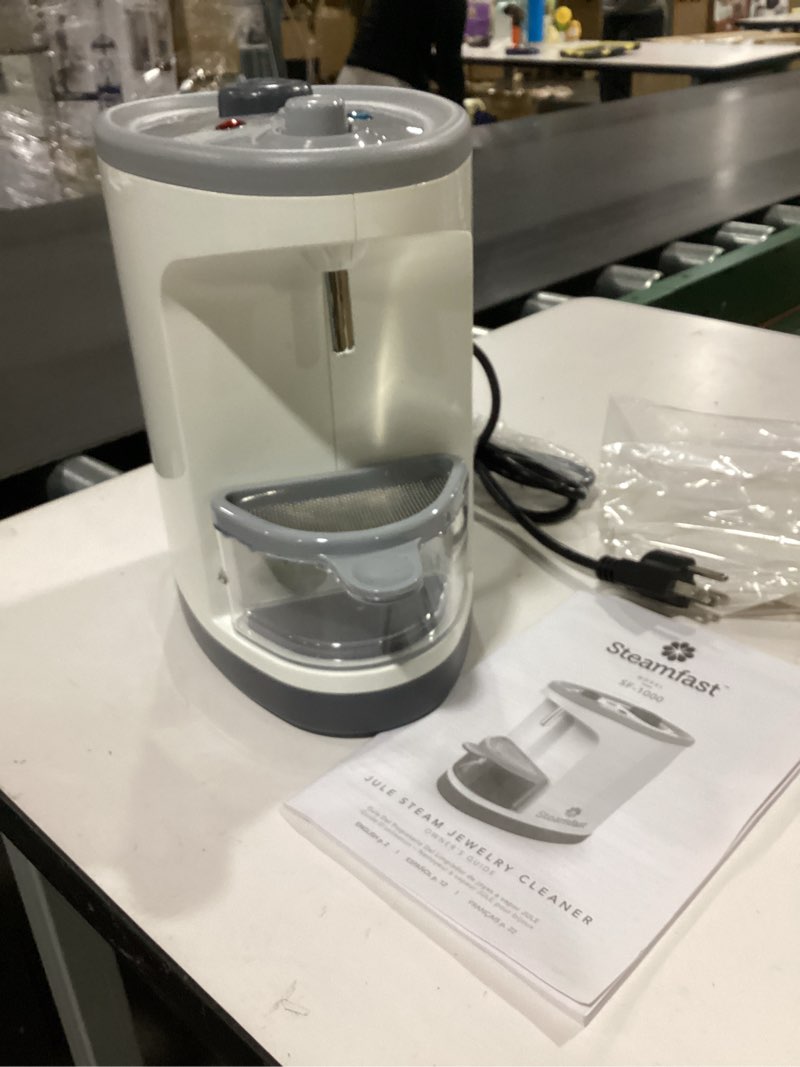 Condition photo showing As Is for ** incomplete** (tweezers missing) Steamfast SF-1000 JULE Steam Jewelry Cleaner, LED Lighting, Chemical Free, 15 Minute Run-Time, Included Cleaning Accessories, 12-Ounce Water Tank, Quick Heat-Up Time, White Tabletop