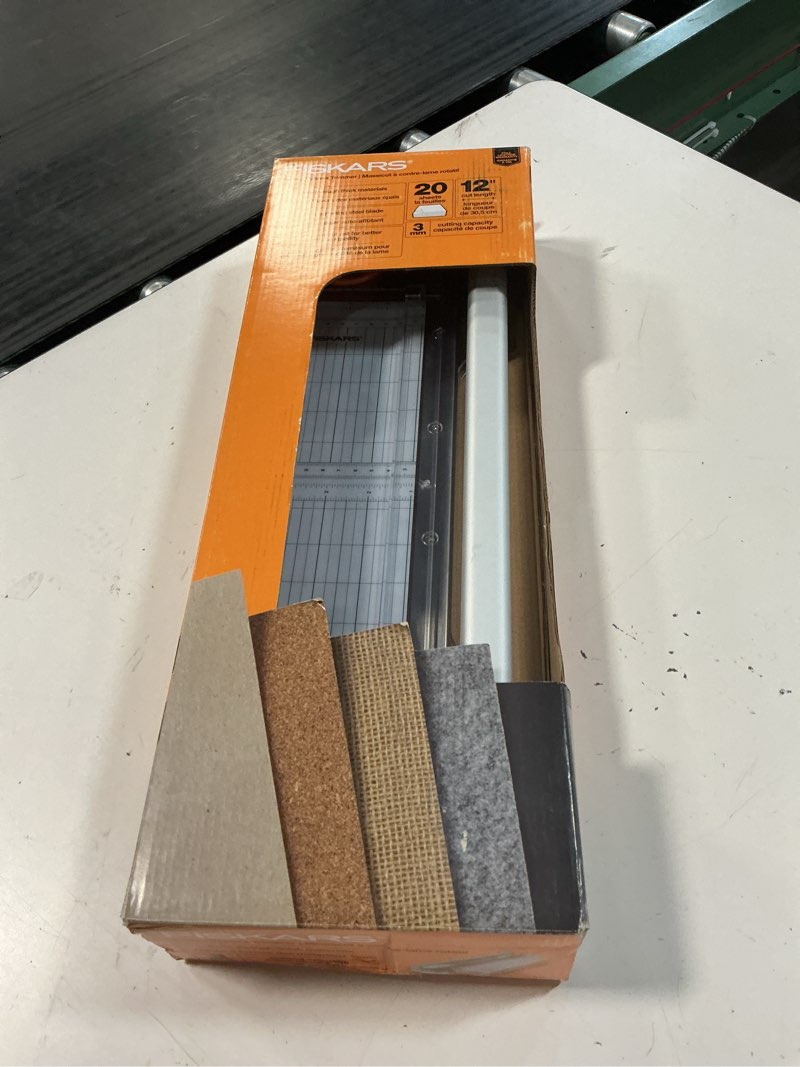 Condition photo showing New/Like New for fiskars compact rotary bypass paper trimmer - 12" cut length - portable size with hang hole - cuts thicker materials (vinyl, leather, chipboard, cardstock, etc) - arts & crafts tool
