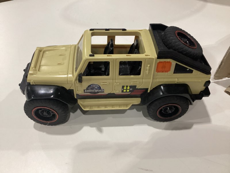 Condition photo showing As Is for matchbox rc jurassic world dominion jeep gladiator, 6-inch dracorex dinosaur figure, remote-control toy car with auto-capture claw, incomplete